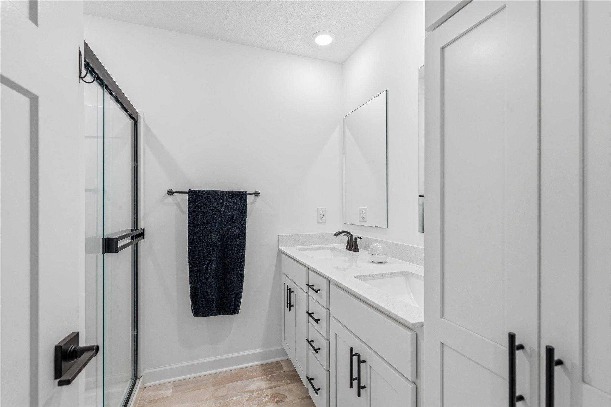 Private primary bath has double sinks
