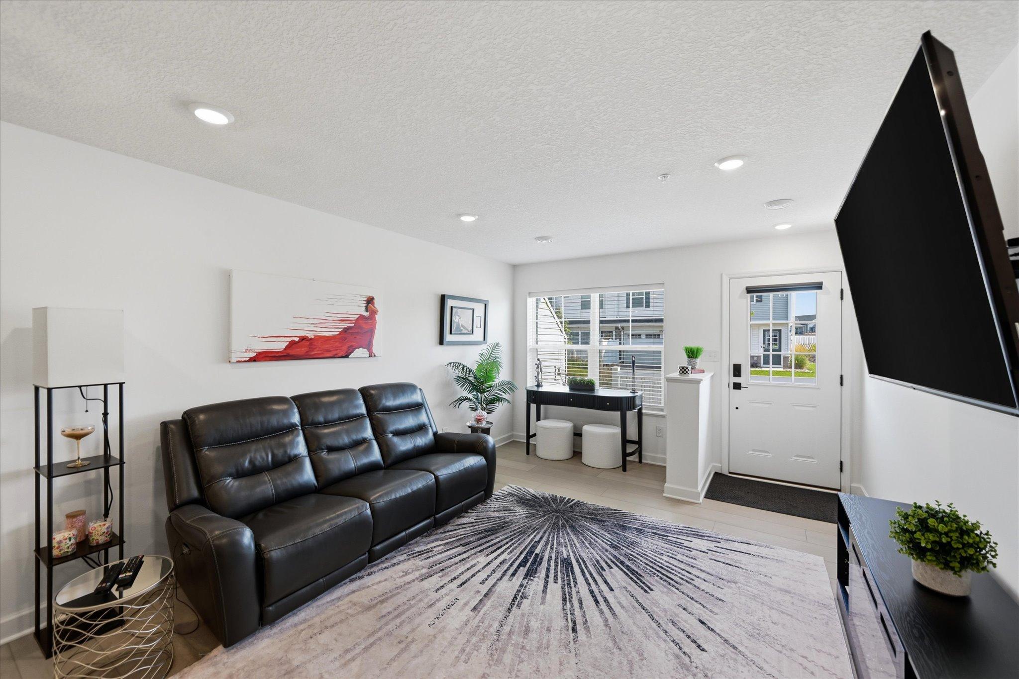 Nice sized living area has bonus space in front of windows for office nook or play area or extra seating