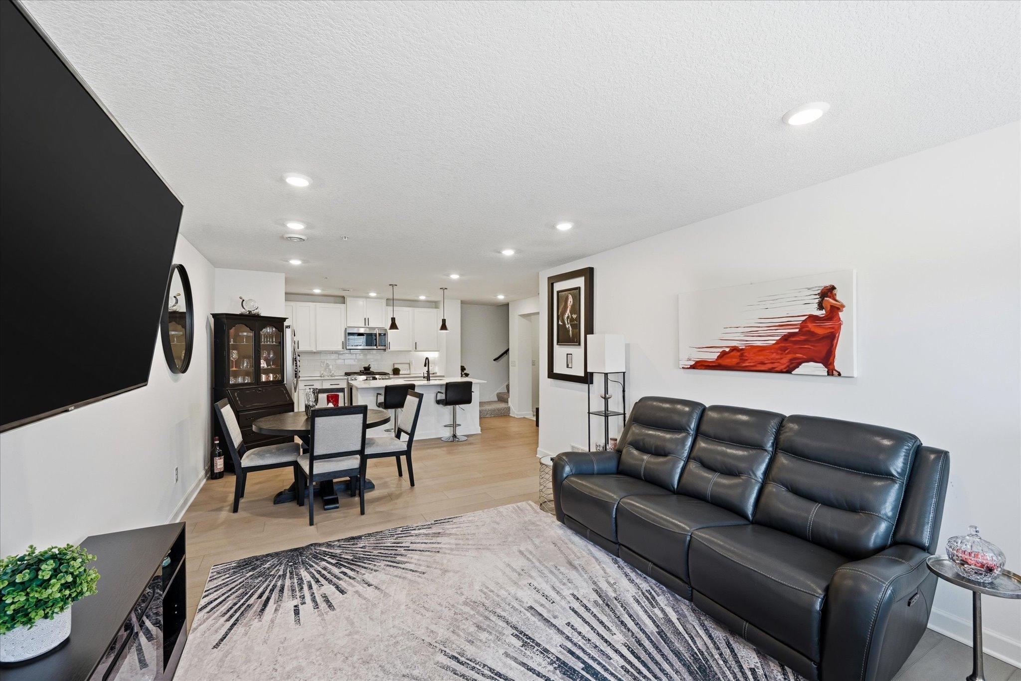 Upgraded with luxury light colored vinyl plank flooring throughout main level