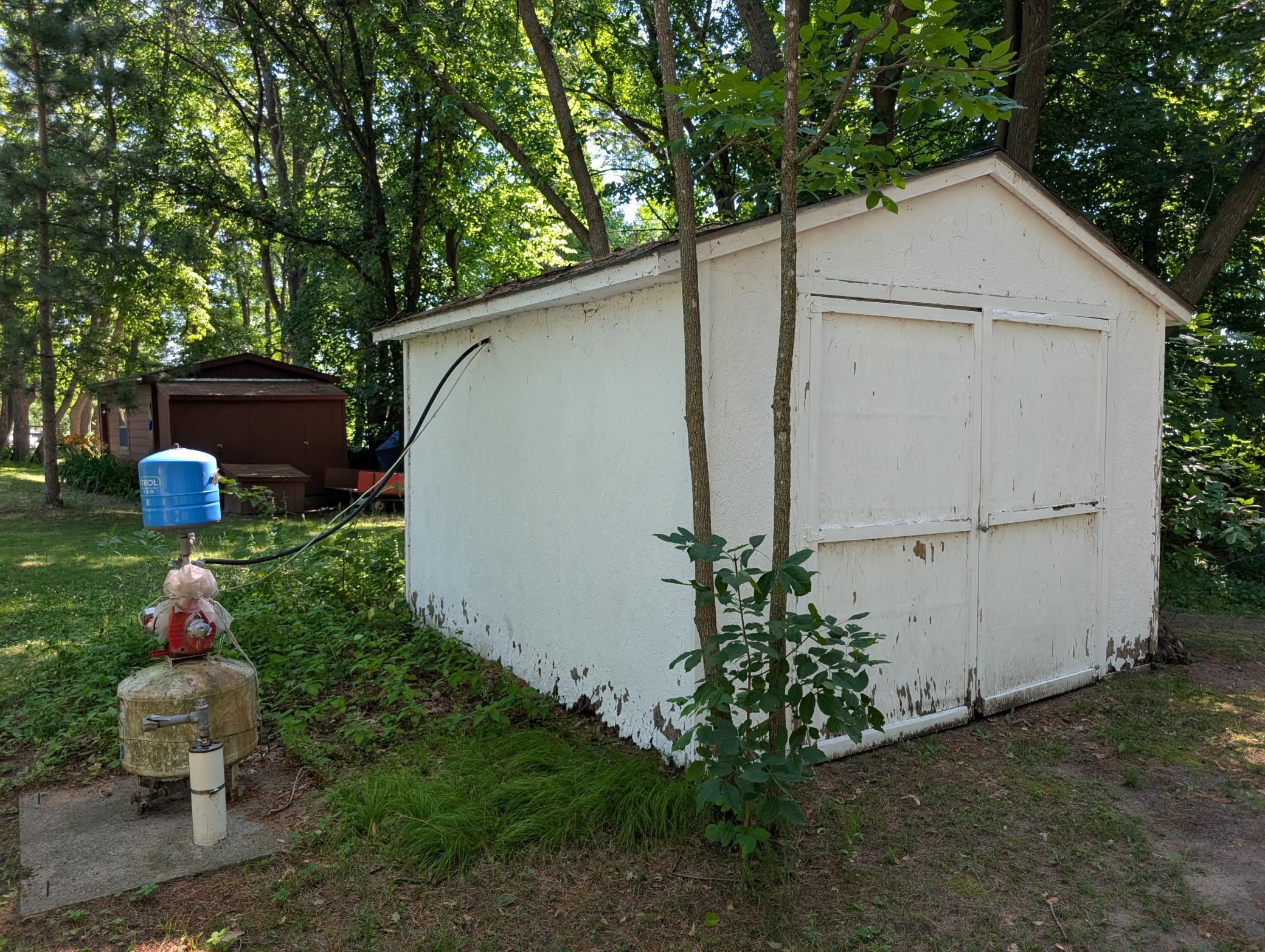 Storage shed and well head.