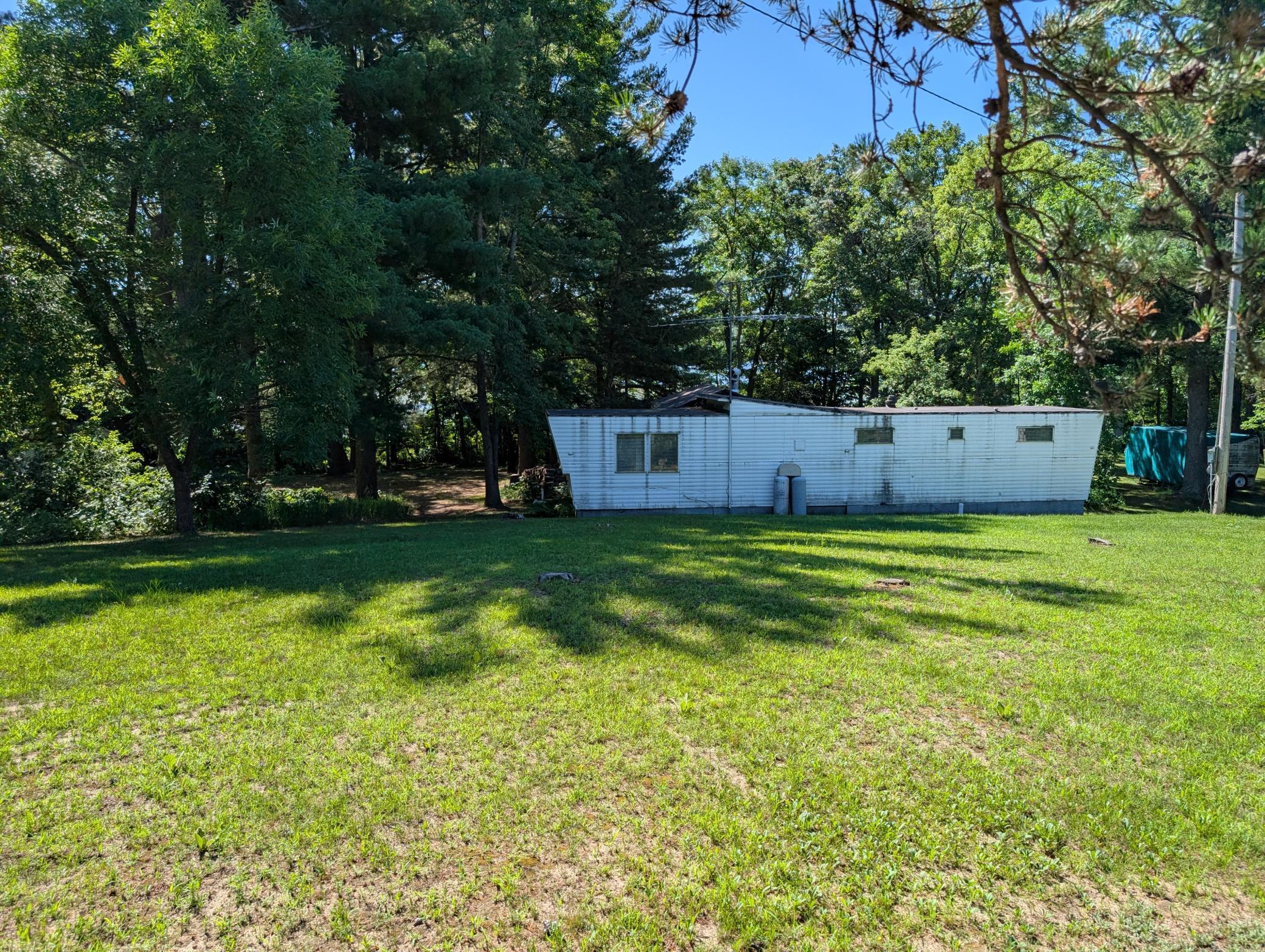 Rehab this trailer or build a new home on this gently sloping lot.