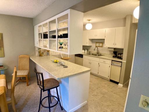 Bright open airy kitchen with breakfast bar counter abundant cupboard space.jpg