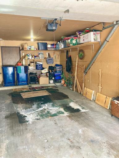 Spacious garage with locked storage space locker.jpg