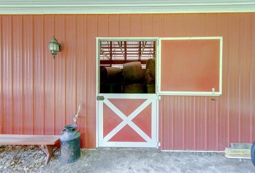 3 box stalls, storage adequate for hay, storage, tack, and tractor. Built in work bench