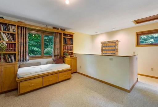 Upper loft with built in Maple daybed and adjacent bookcases plus storage