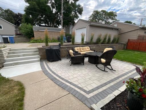 Private stone paver patio and easy-care low-maintenance yard.