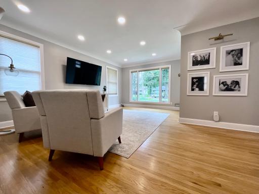 This bright, spacious living room features beautiful oak hardwood flooring and an abundance of natural light from a prominent picture window.