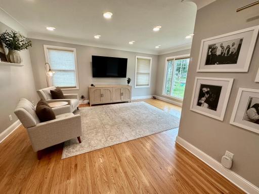 Built-in picture light accents a dedicated gallery wall area.