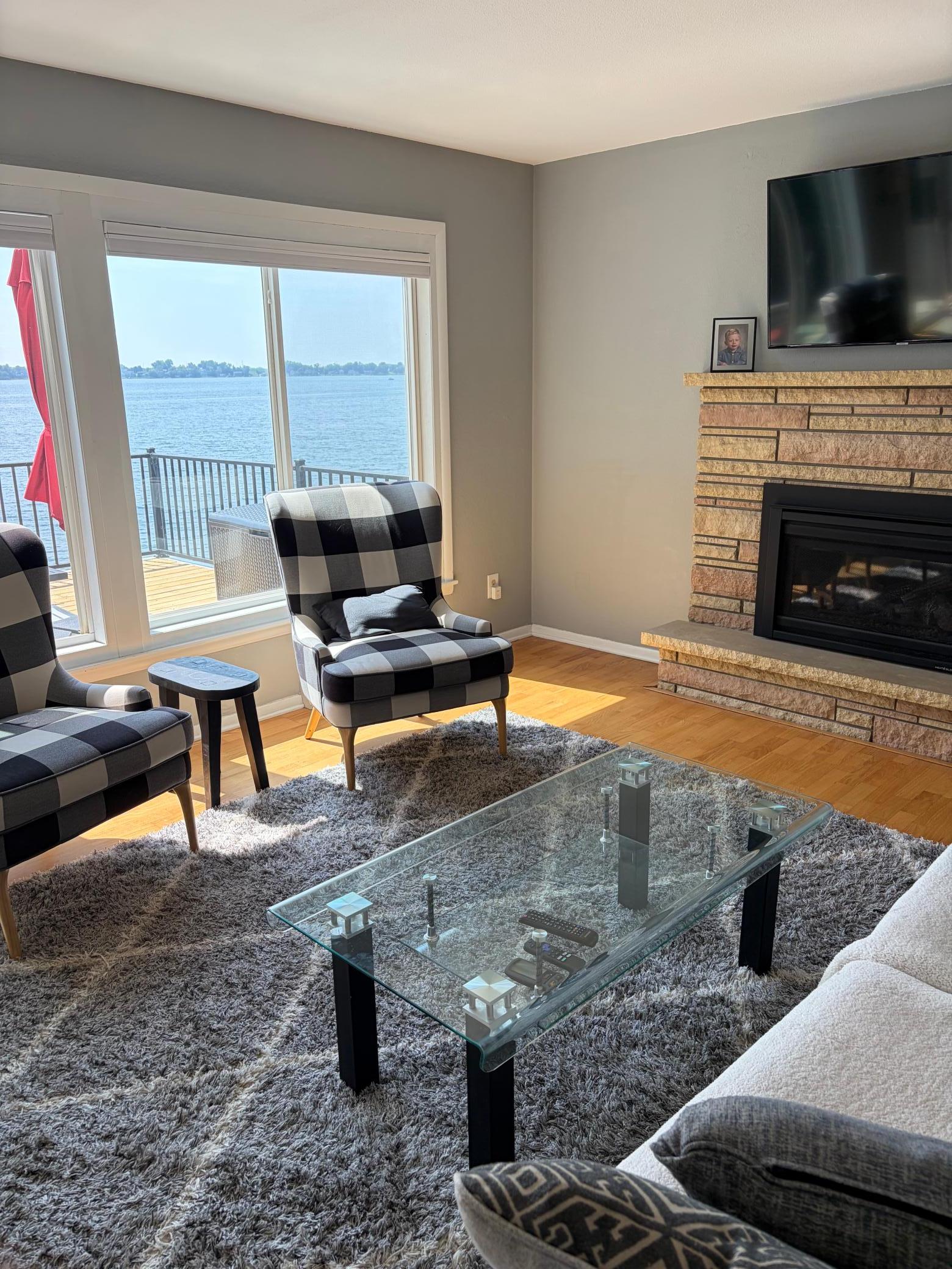Main level living room w gas fireplace and the perfect lake view