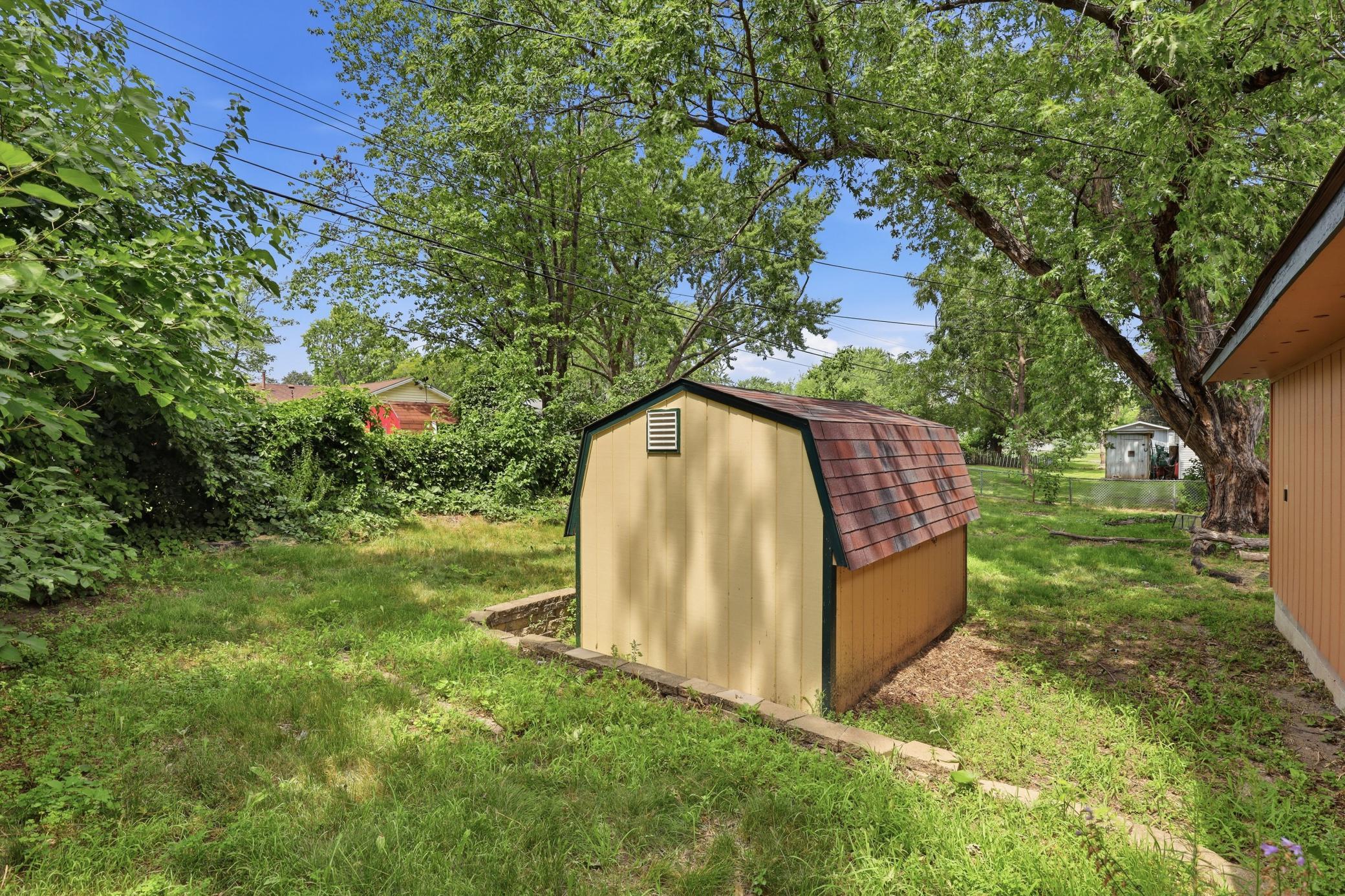 Storage shed behind garage