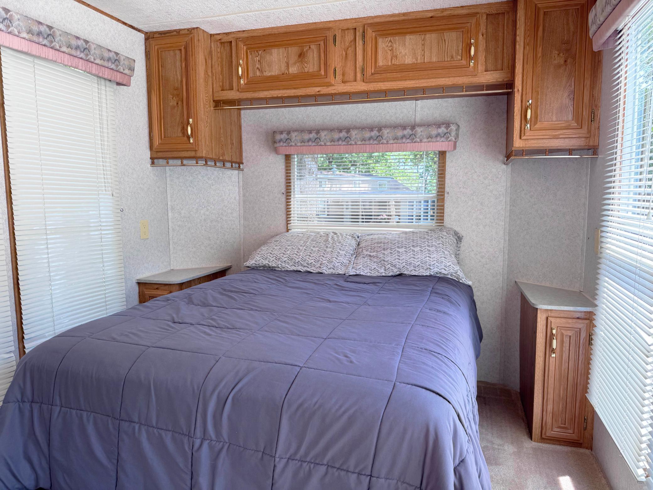 A look at the back bedroom of the camper that features a folding dividing wall.