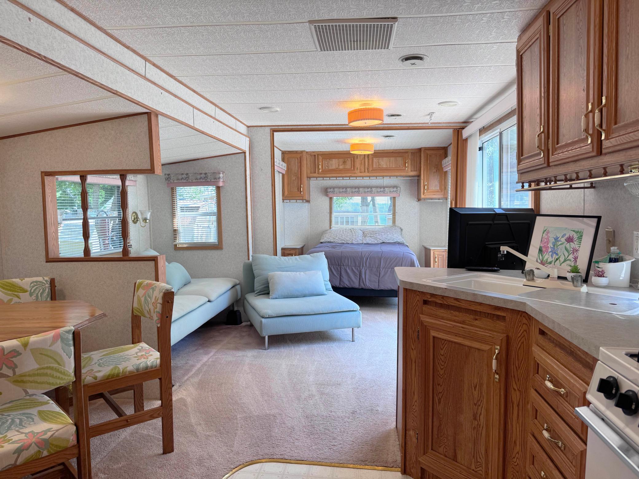 A look inside the camper from the kitchen to the living room and bedroom beyond.