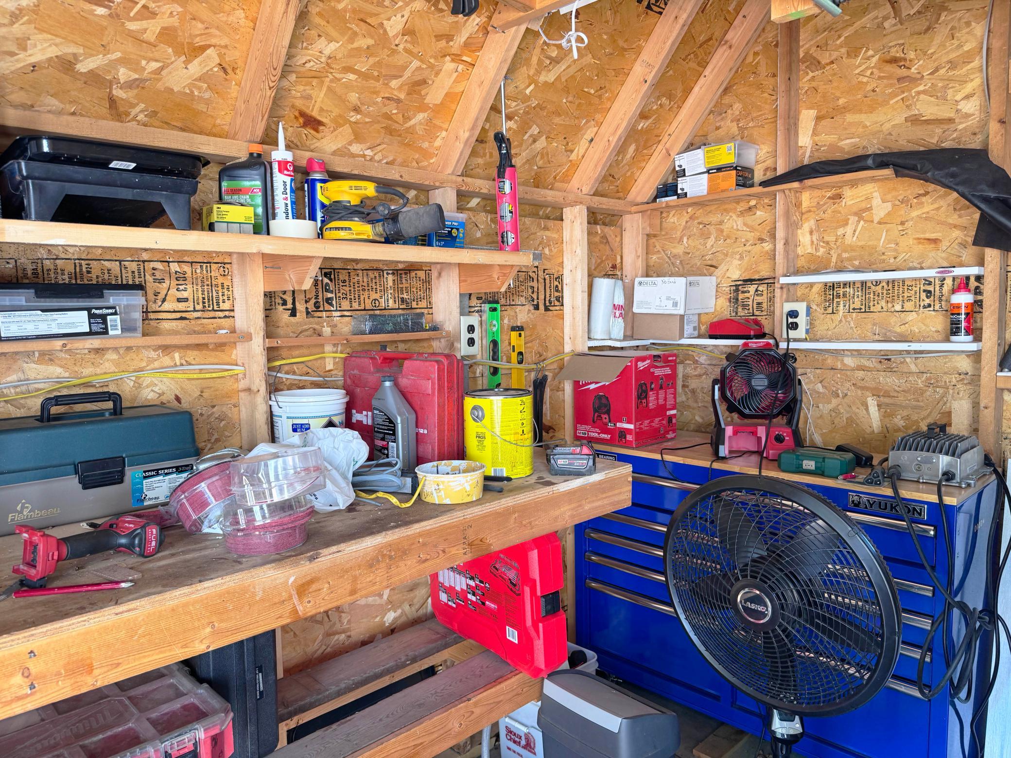 More views inside the shed featuring the workbench.