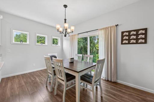 Decorative Windows and Sliding Glass Door make the Dining Area Open and Light