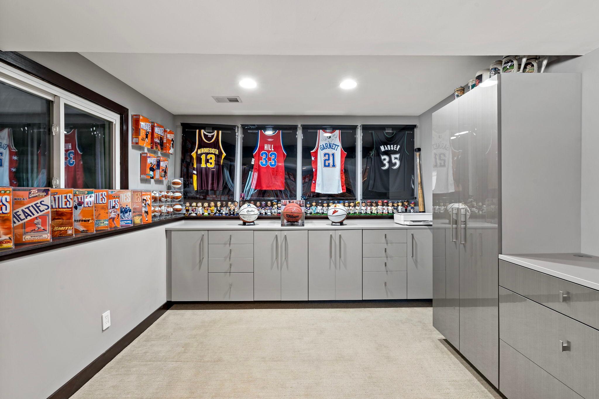 Included in the lower level is a versatile flex room featuring custom built-in cabinetry, expansive storage, and endless possibilities for a home office, hobby room, fitness area, or recreation space