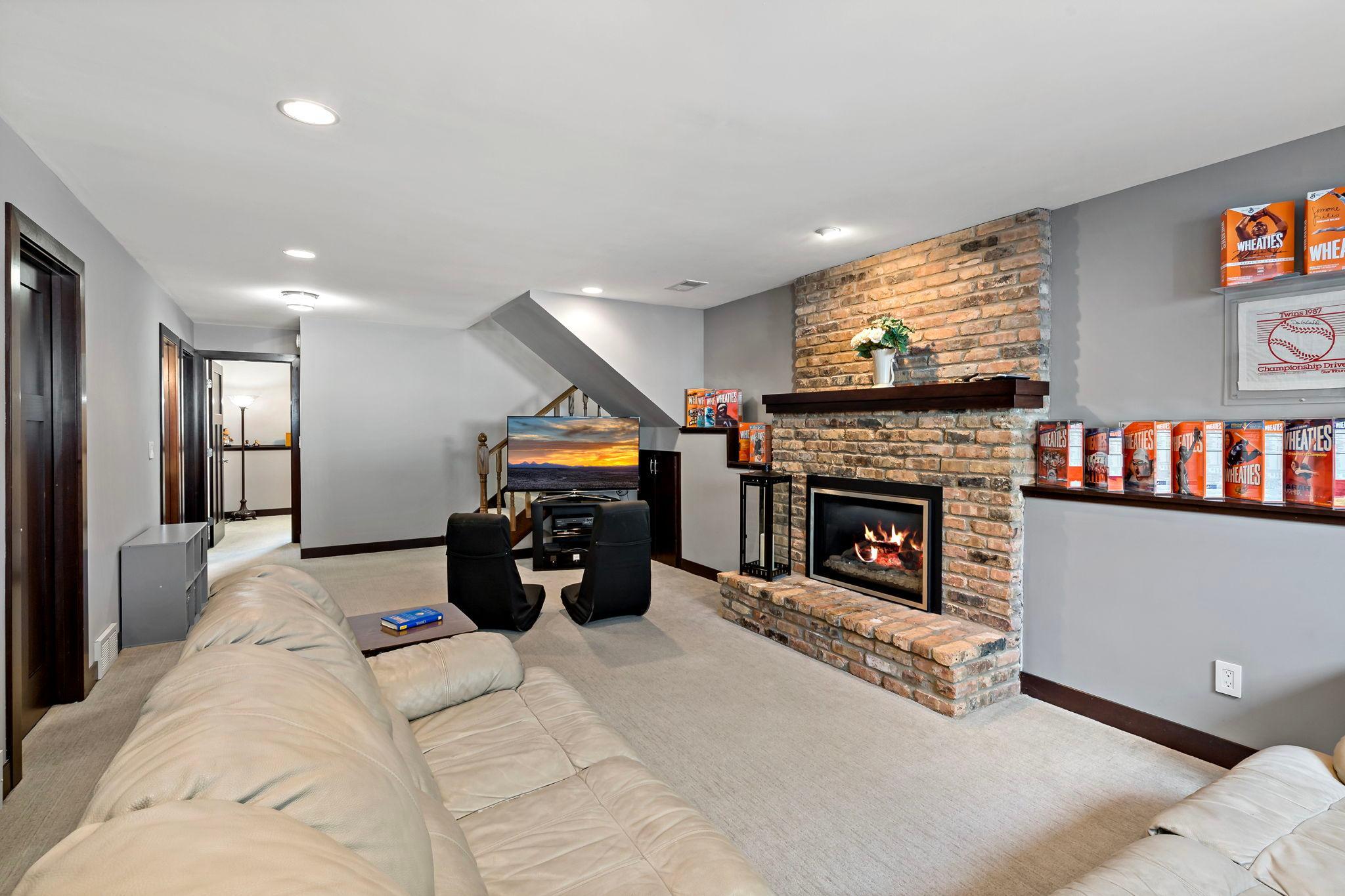 The gas fireplace features a brick surround and hearth with a wood mantle for displaying all of your prized possessions and keepsakes