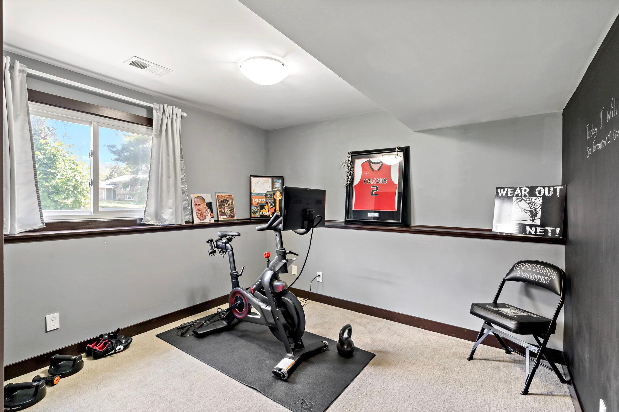The first lower level bedroom being used as an exercise area