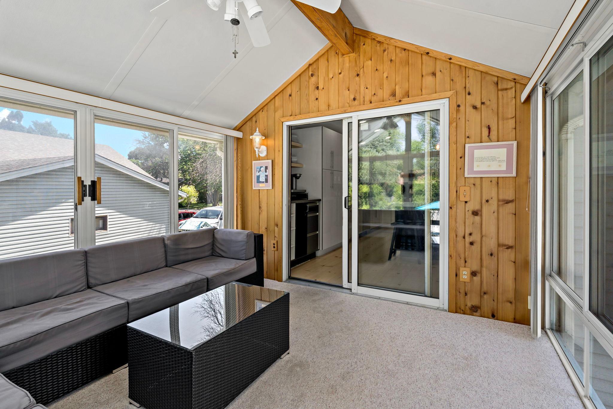 A set up for functional and enjoyable indoor/outdoor living with the three-season porch directly adjacent to the kitchen
