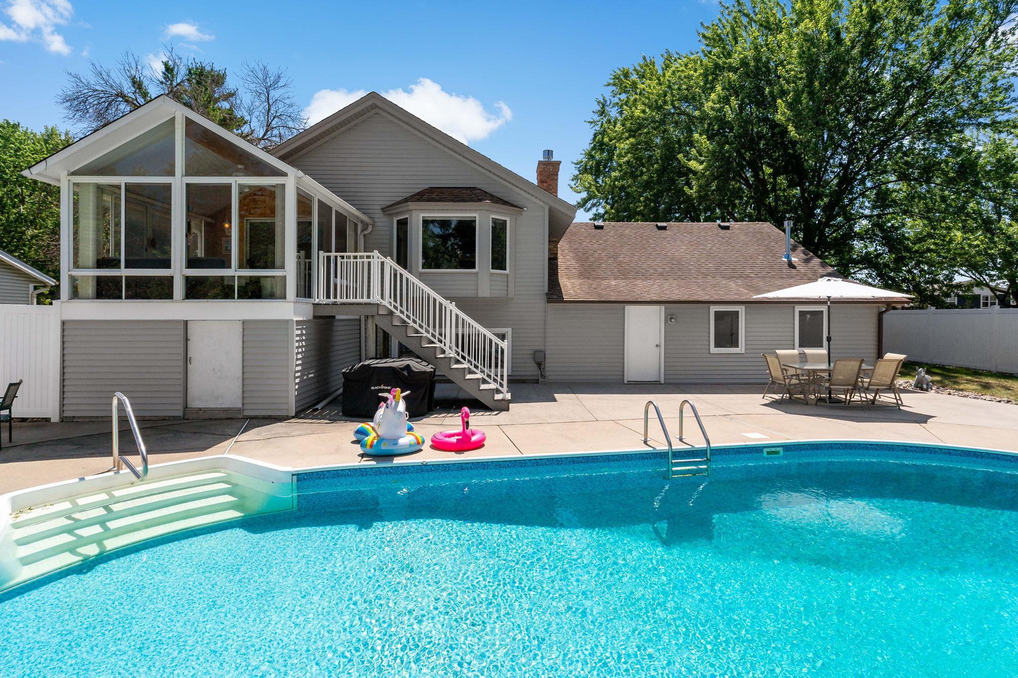 Your own private backyard retreat featuring a sparkling in-ground pool, expansive patio, and fully fenced yard—perfect for relaxing and entertaining