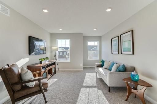 The home's upper level is equally impressive, as it features four bedrooms, two baths, laundry and this game room or loft area, which is sure to be a favorite hangout spot! Photo of model home, color and options will vary.