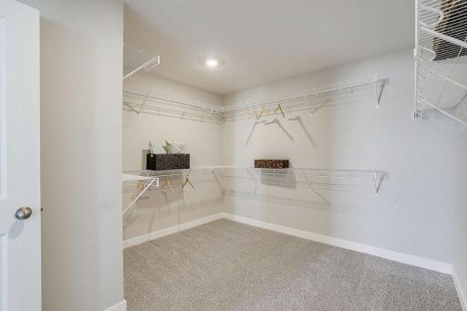Our LARGEST primary suite walk-in closet! Time to go shopping! Photo of model home, color and options will vary.