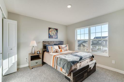 Space is also abundant in each of the home's three secondary bedrooms, all three of which are just steps from the upper-level loft! Photo of model home, color and options will vary.