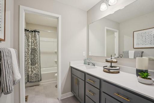 Upper-level hall bath. Stunning cabinetry with additional storage, quartz countertops and more. *Photos used are of a model home.