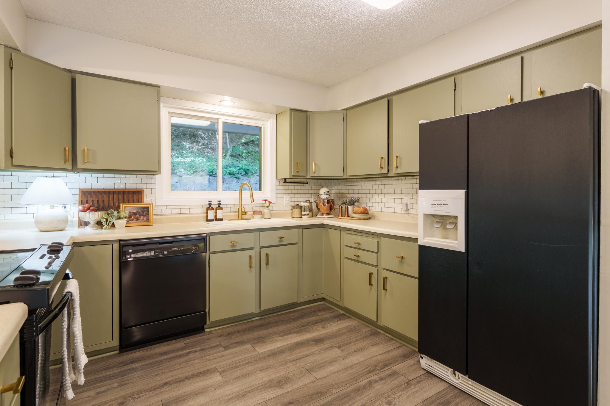 The kitchen cabinets were freshly painted with new hardware in 2025!