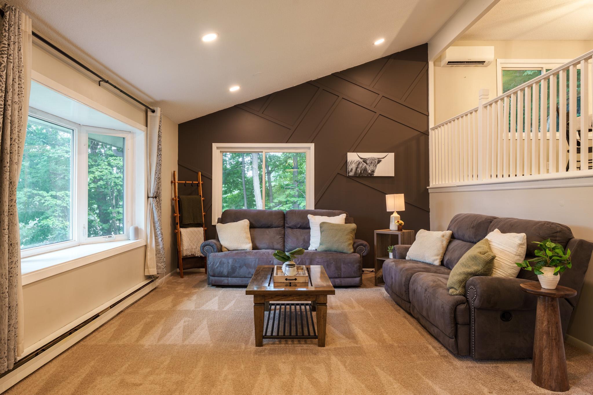 Check out the custom geometric board and batten accent wall (2025) & can lighting (2025)