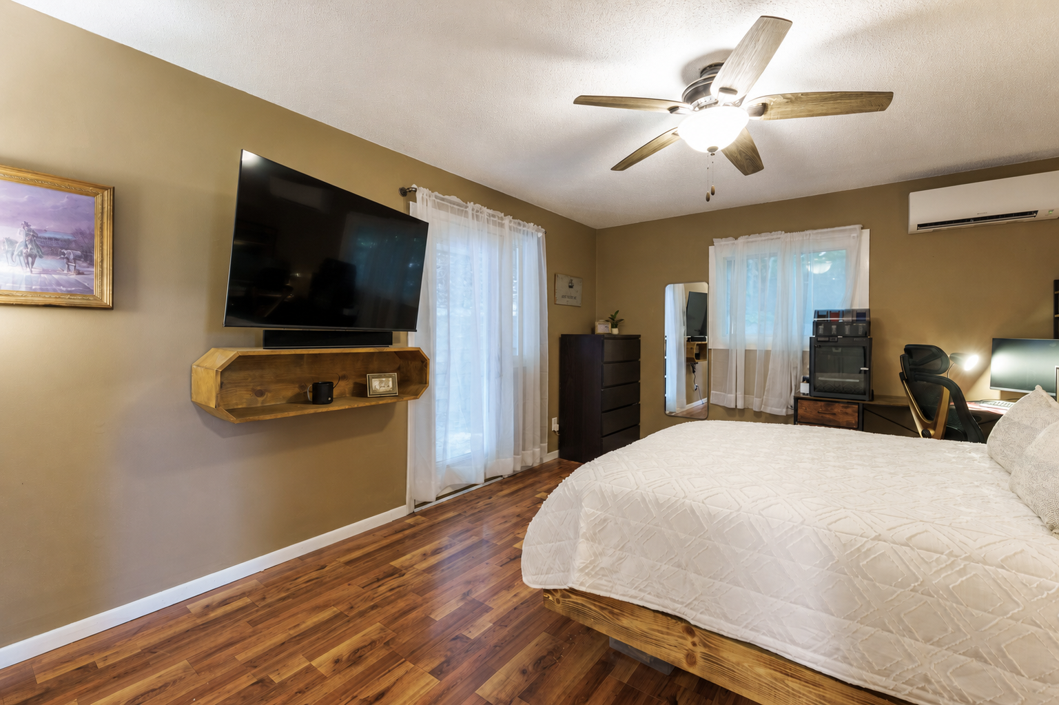 Bedroom 1 on the upper level with a patio door to the backyard