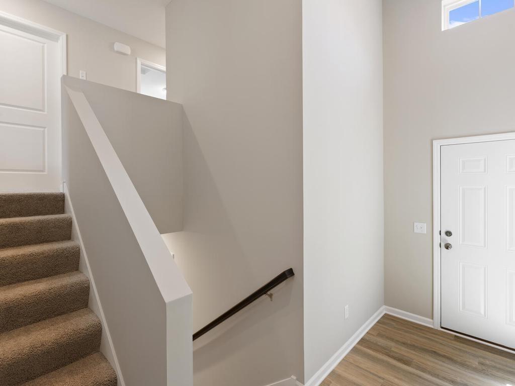 Foyer. Photo taken of another home with similar plan and finishes. Photos and renderings may not depict actual plan, materials, & finishes may vary. All measurements are approximate.