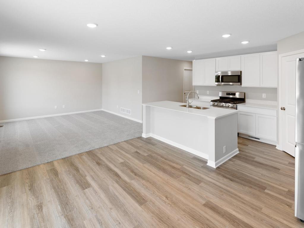 Open Concept. Photo taken of another home with similar plan and finishes. Photos and renderings may not depict actual plan, materials, & finishes may vary. All measurements are approximate.
