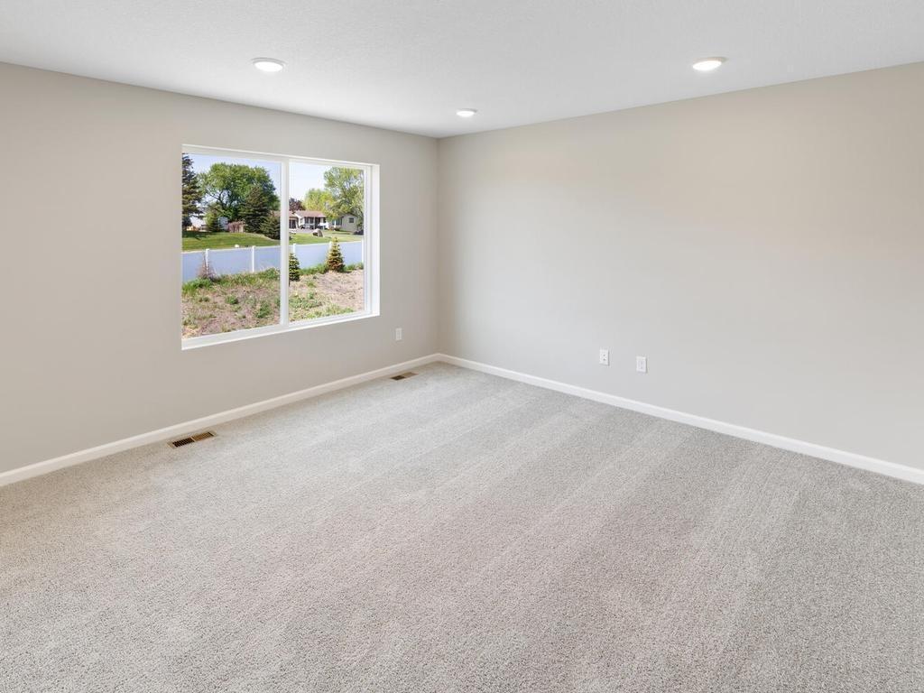 Living Room. Photo taken of another home with similar plan and finishes. Photos and renderings may not depict actual plan, materials, & finishes may vary. All measurements are approximate.