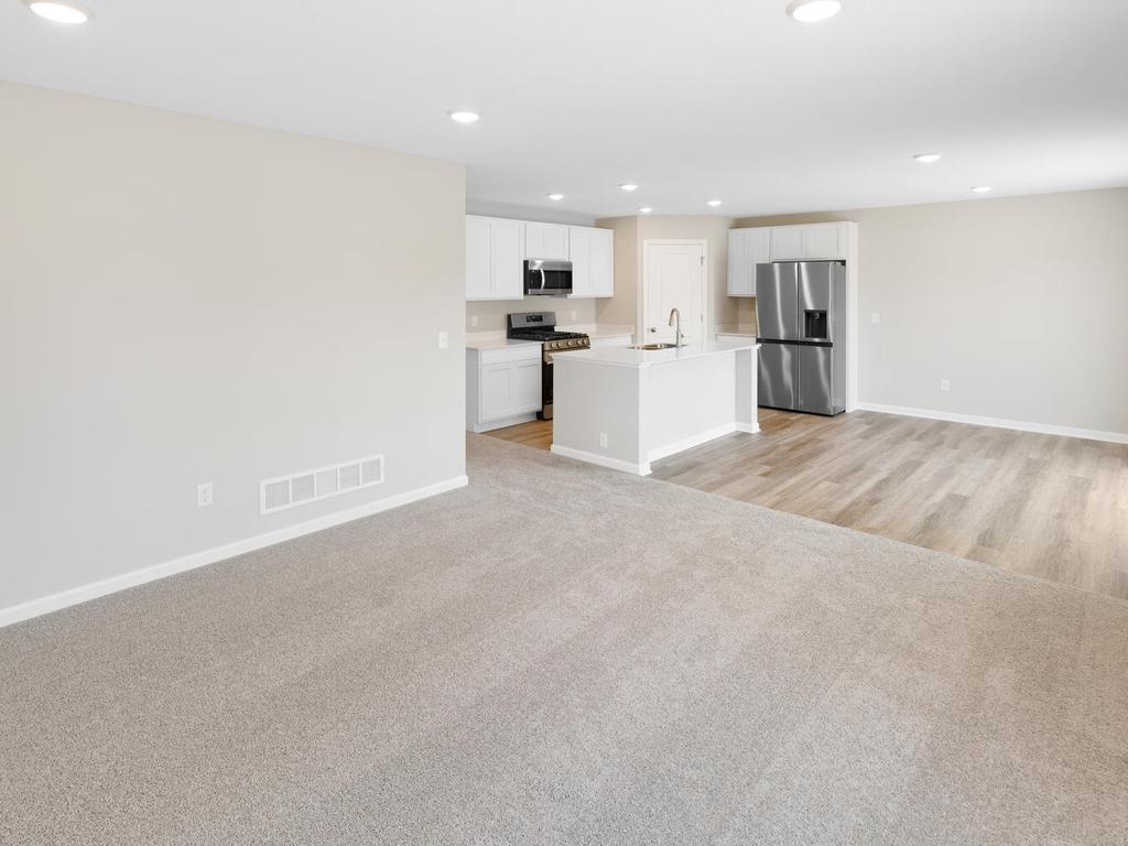 Open Concept. Photo taken of another home with similar plan and finishes. Photos and renderings may not depict actual plan, materials, & finishes may vary. All measurements are approximate.