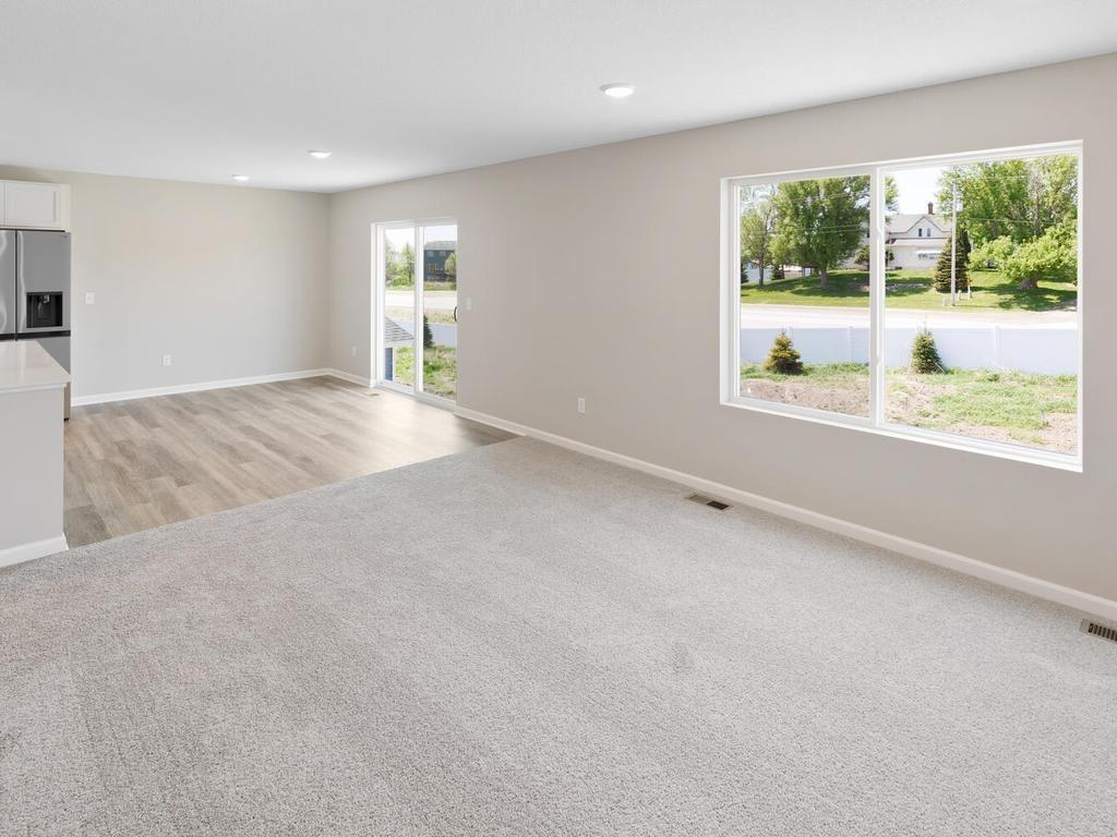 Living Room & Dining. Photo taken of another home with similar plan and finishes. Photos and renderings may not depict actual plan, materials, & finishes may vary. All measurements are approximate.
