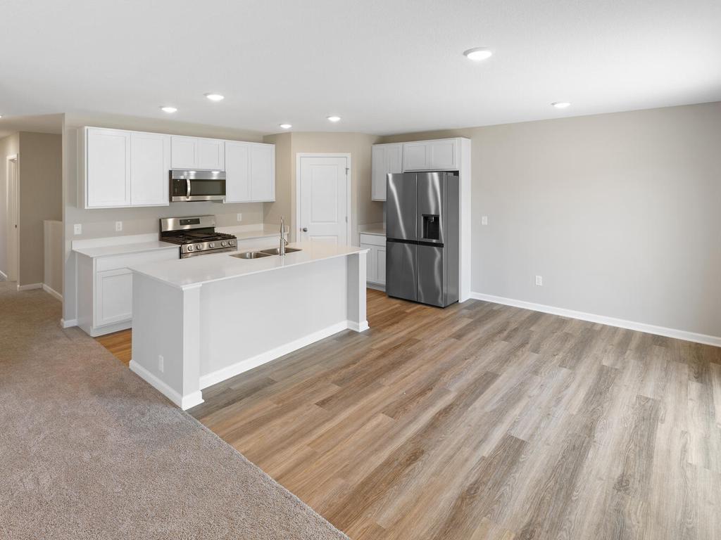 Kitchen & Dining. Photo taken of another home with similar plan and finishes. Photos and renderings may not depict actual plan, materials, & finishes may vary. All measurements are approximate.