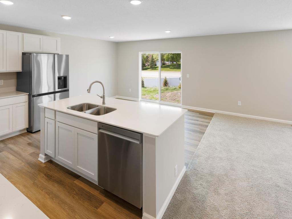 Kitchen & Dining. Photo taken of another home with similar plan and finishes. Photos and renderings may not depict actual plan, materials, & finishes may vary. All measurements are approximate.
