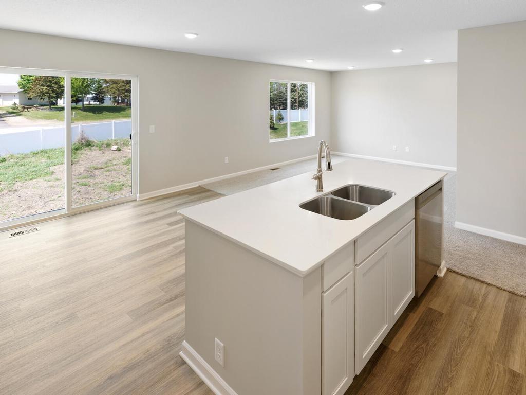 Open Concept. Photo taken of another home with similar plan and finishes. Photos and renderings may not depict actual plan, materials, & finishes may vary. All measurements are approximate.