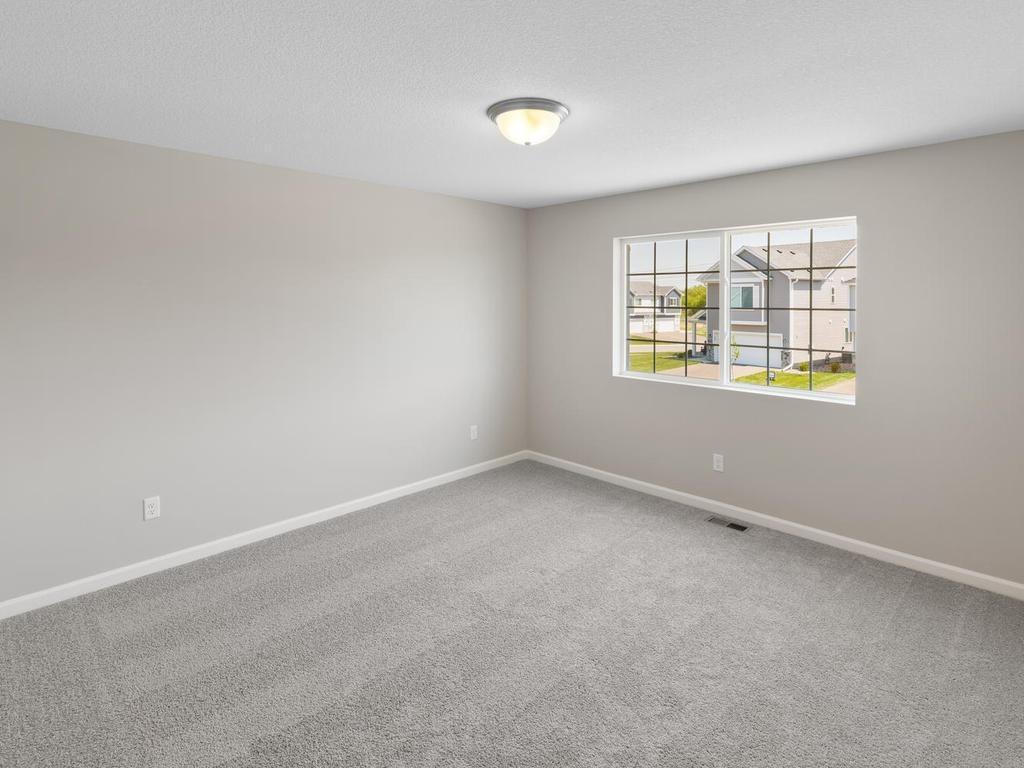 Primary Suite. Photo taken of another home with similar plan and finishes. Photos and renderings may not depict actual plan, materials, & finishes may vary. All measurements are approximate.