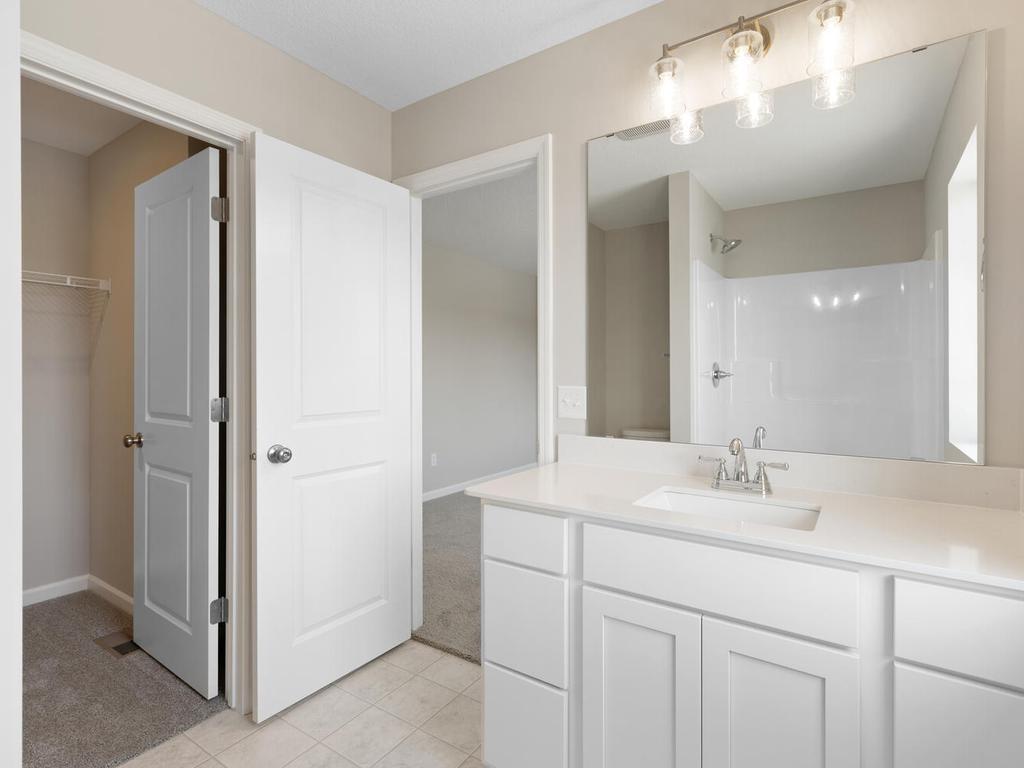Primary Bath. Photo taken of another home with similar plan and finishes. Photos and renderings may not depict actual plan, materials, & finishes may vary. All measurements are approximate.