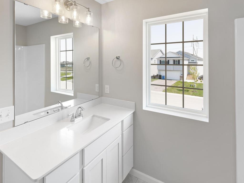 Primary Bath. Photo taken of another home with similar plan and finishes. Photos and renderings may not depict actual plan, materials, & finishes may vary. All measurements are approximate.
