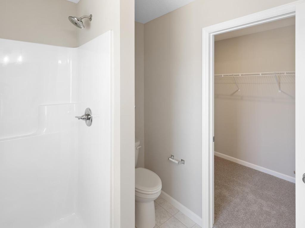 Primary Bath. Photo taken of another home with similar plan and finishes. Photos and renderings may not depict actual plan, materials, & finishes may vary. All measurements are approximate.