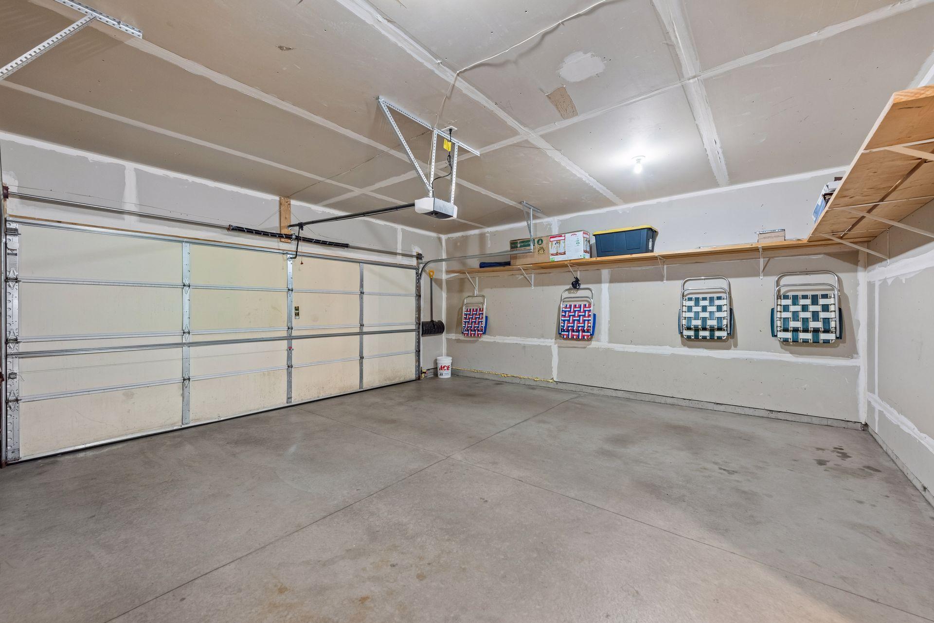 The garage is a little wider than 2 car which gives enough space for the trash cans and 2 cars. Shelving provides space to store totes and miscellaneous items above ground and out of the way.