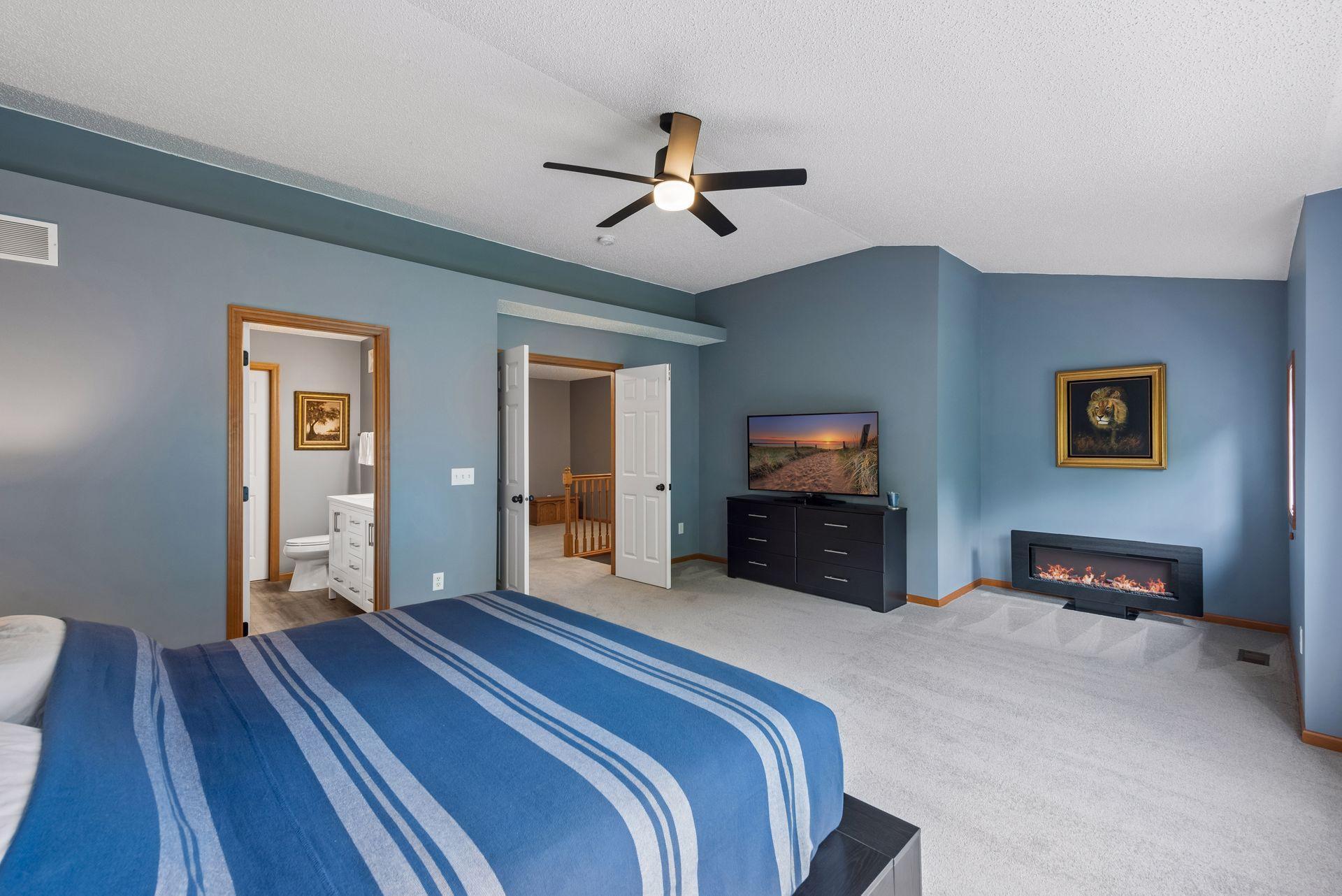 The other end of the primary bedroom. There is space for a sitting area with it's own small window. Enjoy the ambiance and heat from the electric fireplace, which is included.