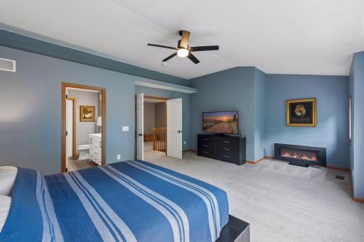 The other end of the primary bedroom. There is space for a sitting area with it's own small window. Enjoy the ambiance and heat from the electric fireplace, which is included.