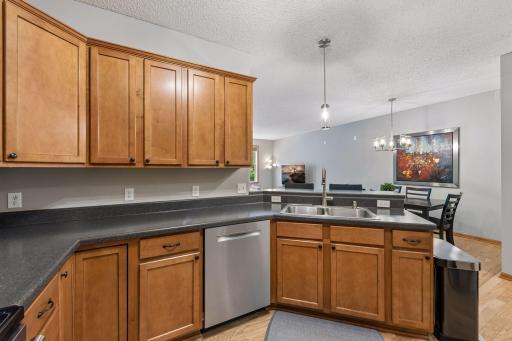 Stay connected with guests while you're in the kitchen. Check out the sleek and modern lighting that really brightens up the spaces.