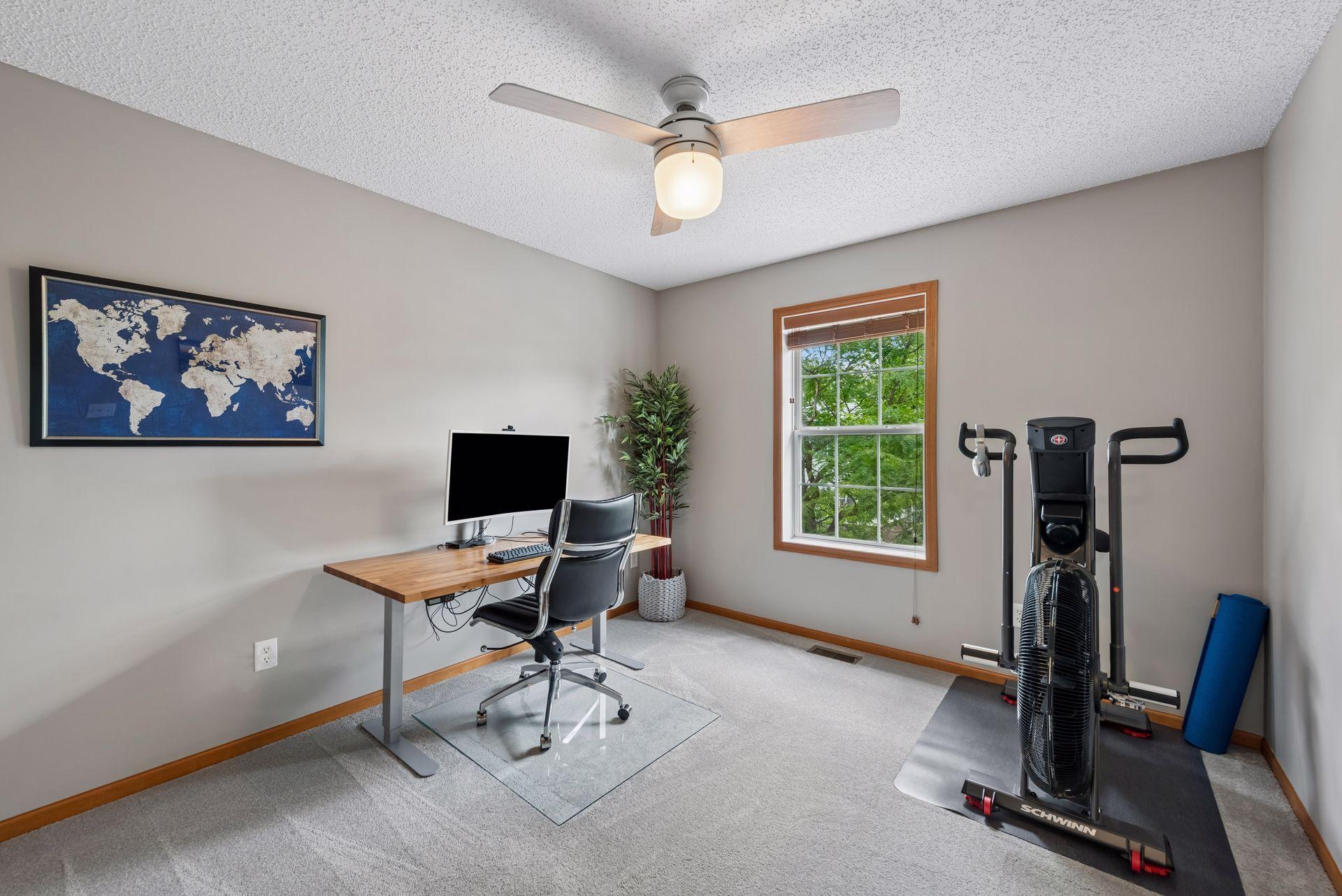 Bedroom 3 with updated ceiling fan, blinds and carpet. The bedroom has a great tree outside the window, providing a nice view and sun protection. This may be the only surviving tree along the driveways, due to the seller's care and watering.