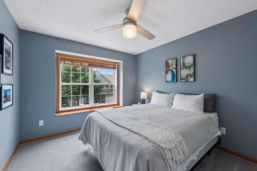 2nd bedroom is spacious with nice windows. New carpet 2024, updated ceiling fan and newer wood slat blinds.