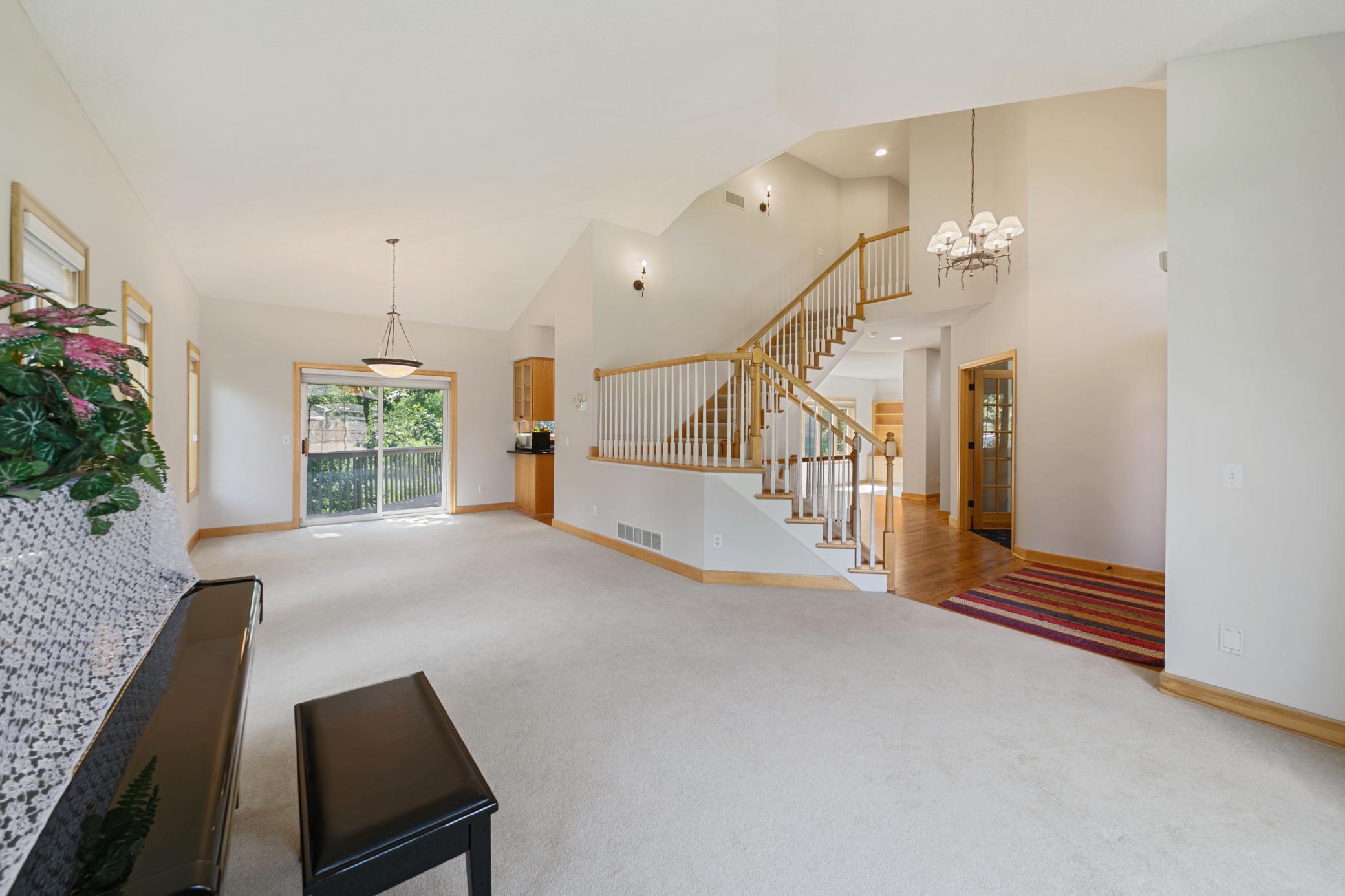 Living/dining and view of stairs leading to upper level