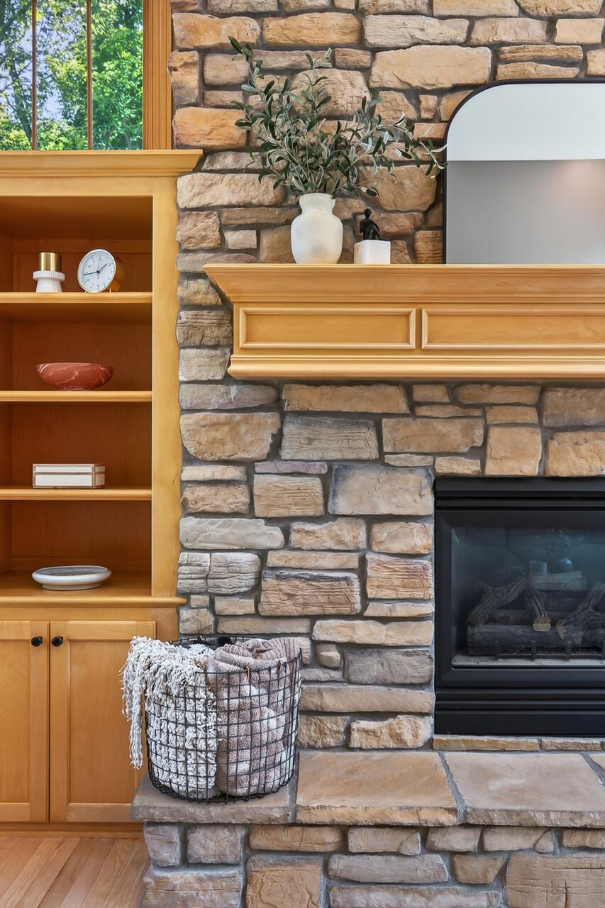 Stone surround and designer mantle make this gas fireplace a show stopper.